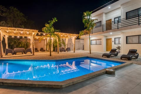 Property building, Patio, Night, Solarium, Pool view, Swimming pool, Swimming pool, sunbed