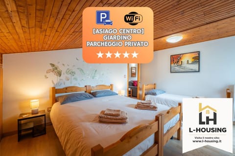 Bed, Property logo or sign, Photo of the whole room, Logo/Certificate/Sign, Bedroom, Text overlay, Certificate/Award, towels