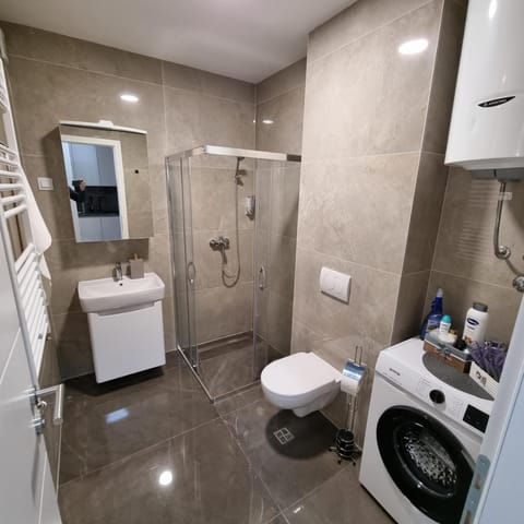 Shower, Toilet, Bathroom, Bath, bidet, towels, washing machine, dryer