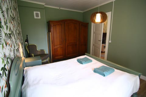 Bed, towels, wardrobe