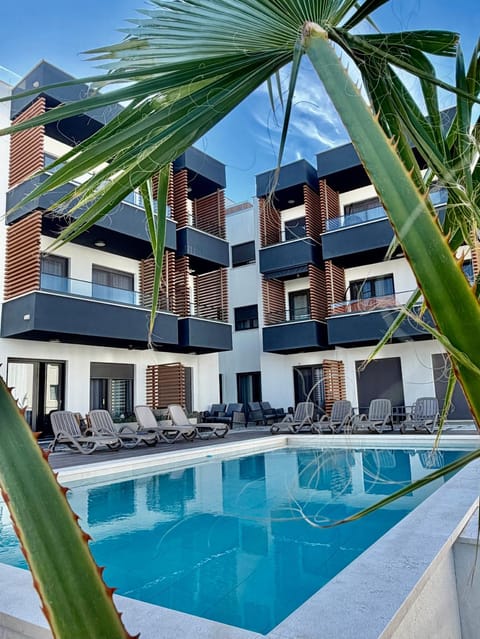 Property building, Pool view, Swimming pool, sunbed