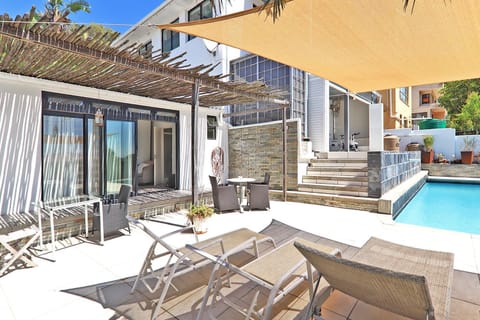 Property building, Patio, Pool view, Swimming pool, sunbed