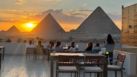 Property building, Restaurant/places to eat, Day, People, Natural landscape, View (from property/room), Banquet/Function facilities, Landmark view, Mountain view, Sunrise, Sunset, group of guests