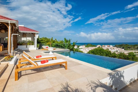 Property building, Patio, Day, Natural landscape, View (from property/room), Pool view, Sea view, Swimming pool, sunbed