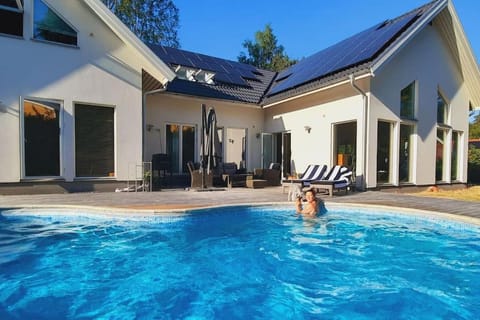 Property building, Patio, Pool view, Swimming pool, sunbed