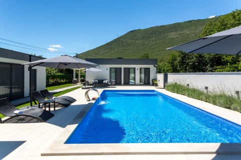 Property building, Patio, Natural landscape, Mountain view, Pool view, Swimming pool, sunbed