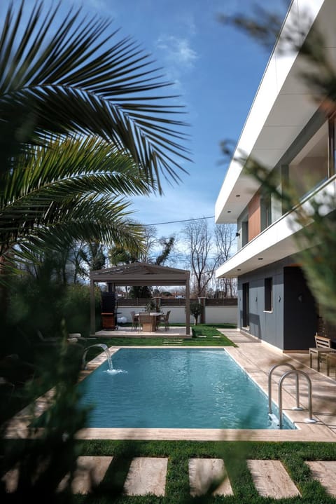 Property building, Patio, Pool view, Swimming pool, sunbed