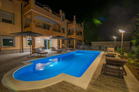 Property building, Patio, Night, Pool view, Swimming pool, sunbed