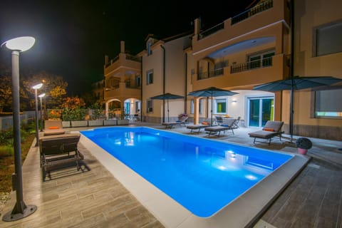 Property building, Patio, Night, Pool view, Swimming pool, sunbed