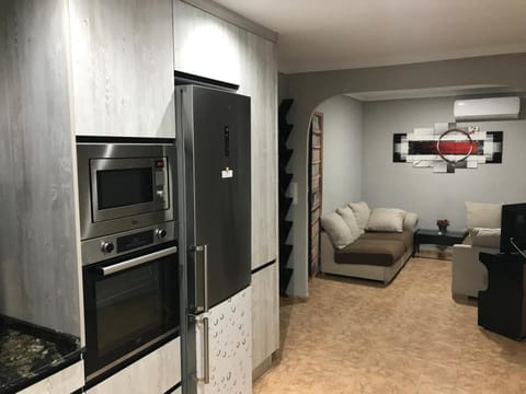 Kitchen or kitchenette, Living room, oven, stove, toaster, air conditioner
