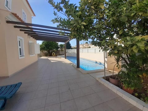 Property building, Patio, Pool view, Swimming pool, sunbed