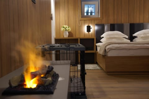 Bed, Photo of the whole room, Decorative detail, Bedroom, fireplace, towels, air conditioner