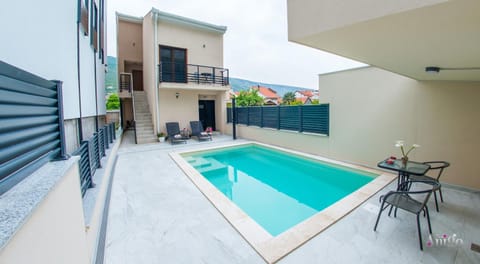 Property building, Patio, Pool view, Swimming pool, sunbed