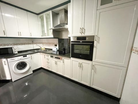 Kitchen or kitchenette, microwave, oven, washing machine