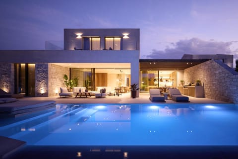 Property building, Patio, Night, Natural landscape, Living room, Seating area, Pool view, Swimming pool, sunbed