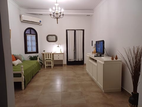 Bed, TV and multimedia, Living room, Seating area, air conditioner