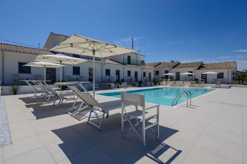 Property building, Patio, Pool view, Swimming pool, sunbed