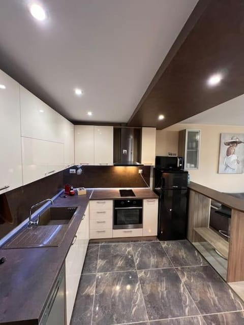 Kitchen or kitchenette, dishwasher, oven, stove