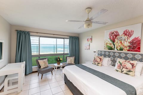 Bed, Seating area, Beach, Bedroom, Sea view, fireplace