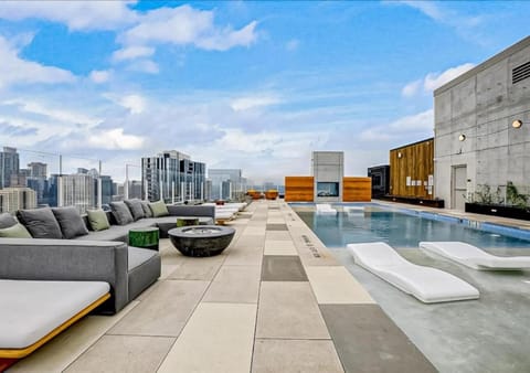 Property building, Patio, Living room, Seating area, City view, Pool view, Swimming pool, sunbed