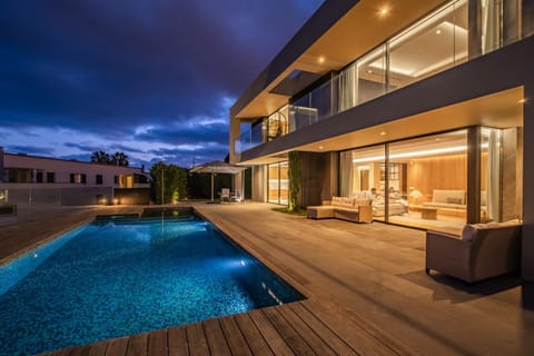 Property building, Patio, Night, Natural landscape, View (from property/room), Balcony/Terrace, Living room, Seating area, Pool view, Swimming pool, sunbed