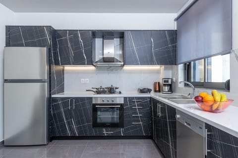 Kitchen or kitchenette, dishwasher, oven, stove