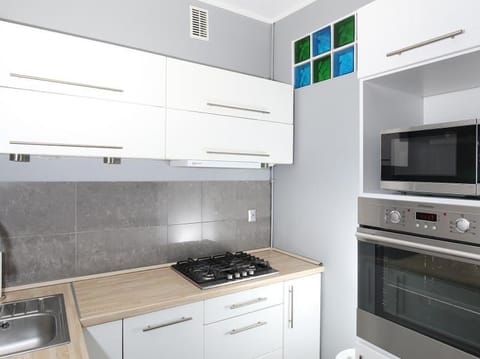 Kitchen or kitchenette, dishwasher, oven, stove