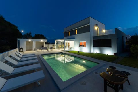 Property building, Patio, Night, Pool view, Swimming pool, sunbed