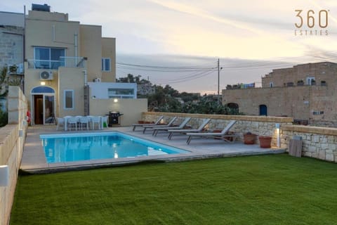 Property building, Patio, Natural landscape, Living room, Seating area, Pool view, Swimming pool, sunbed