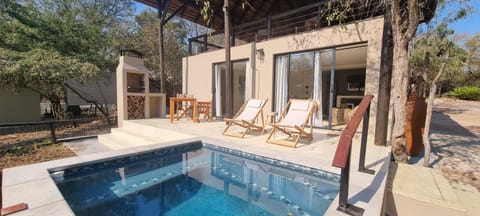 Property building, Patio, Swimming pool, fireplace, sunbed