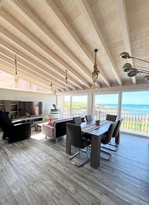 View (from property/room), Balcony/Terrace, Living room, Seating area, Dining area, Beach, Sea view