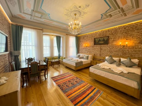 Bed, TV and multimedia, Living room, Seating area, Bedroom