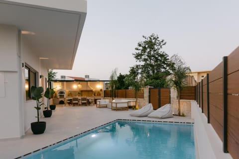 Property building, Patio, Pool view, Swimming pool, sunbed