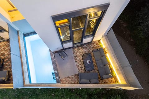 Property building, Patio, Night, Bird's eye view, Seating area, Pool view, Swimming pool, Swimming pool