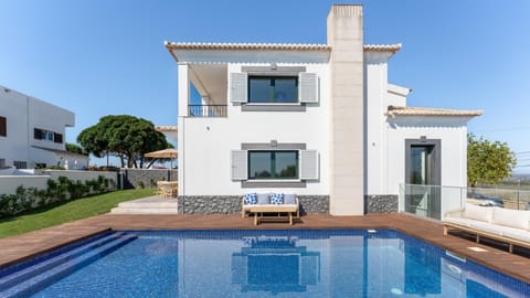 Property building, Patio, Pool view, Swimming pool, sunbed