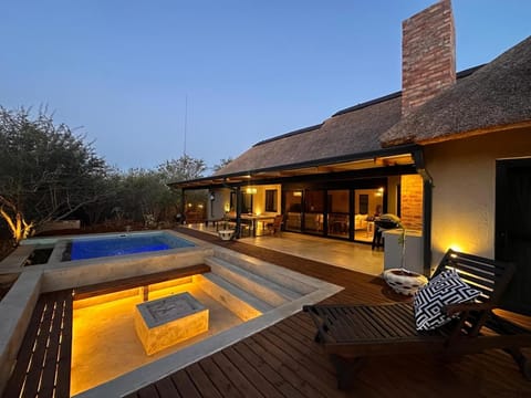 Property building, Patio, Natural landscape, Pool view, Swimming pool, sunbed