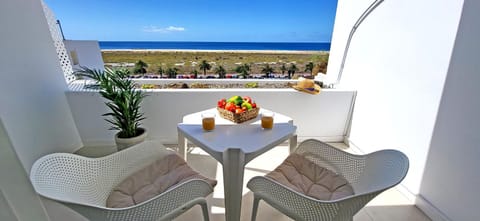 View (from property/room), Balcony/Terrace, Seating area, Dining area, Beach, Sea view