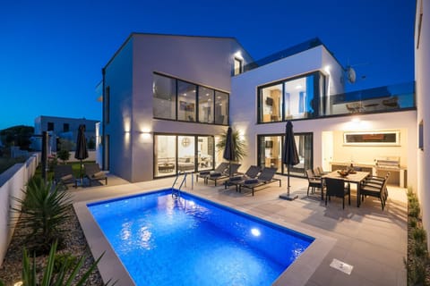 Property building, Night, Seating area, Pool view, Swimming pool, sunbed