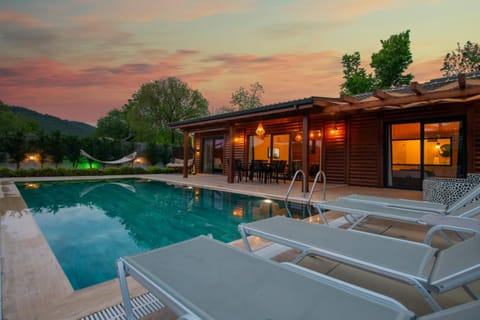 Property building, Patio, Natural landscape, Pool view, Swimming pool, Sunset, sunbed