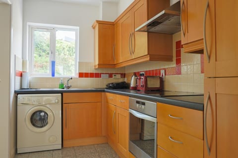 Kitchen or kitchenette, dishwasher, oven, stove, toaster, washing machine, dryer