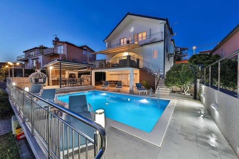 Property building, Patio, Night, Pool view, Swimming pool, Swimming pool, sunbed