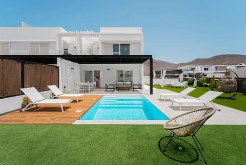 Property building, Patio, Pool view, Swimming pool, sunbed