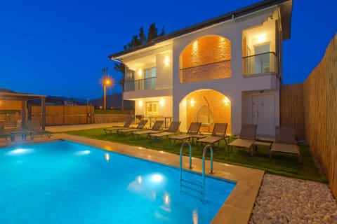 Property building, Patio, Night, Pool view, Swimming pool, sunbed
