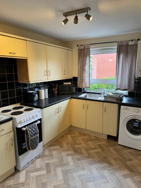 Kitchen or kitchenette, oven, stove, washing machine