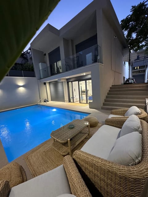 Property building, Patio, Night, Balcony/Terrace, Living room, Seating area, Pool view