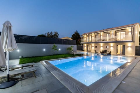 Property building, Patio, Night, Balcony/Terrace, Pool view, Swimming pool, sunbed