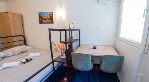 Bed, Dining area, towels, wardrobe