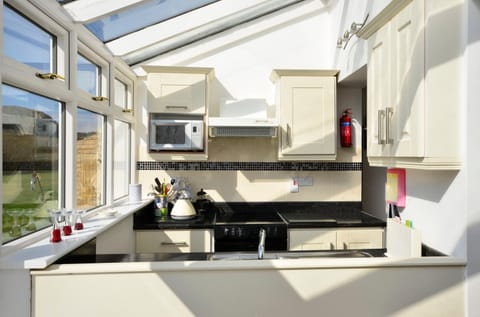 Kitchen or kitchenette, microwave, oven, stove