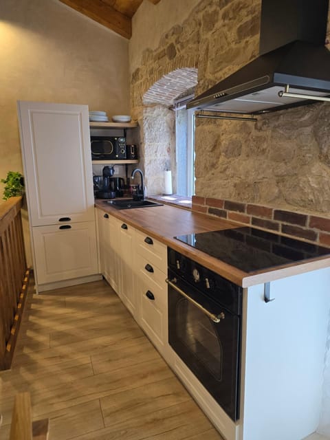 Kitchen or kitchenette, dishwasher, oven, stove