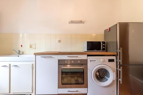 Kitchen or kitchenette, dishwasher, oven, stove, washing machine